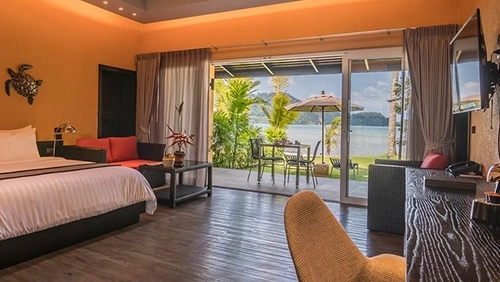Beachfront room interior with sea view terrace at Peninsula Beach Resort